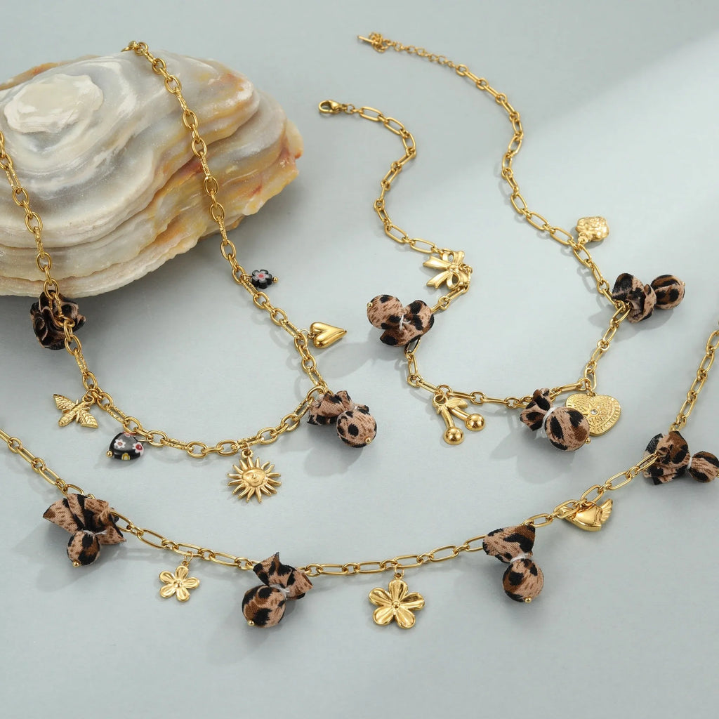 Women's gold-plated stainless steel necklace with leopard, love heart, and flowers pendant on an adjustable chain.