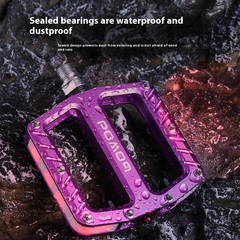 Pair of aluminium alloy bicycle pedals with integrated LED lights in multiple colour options