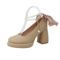 Beige women's Mary Jane shoes with a chunky heel, round toe, and pearl-decorated ankle strap buckle on a white background.