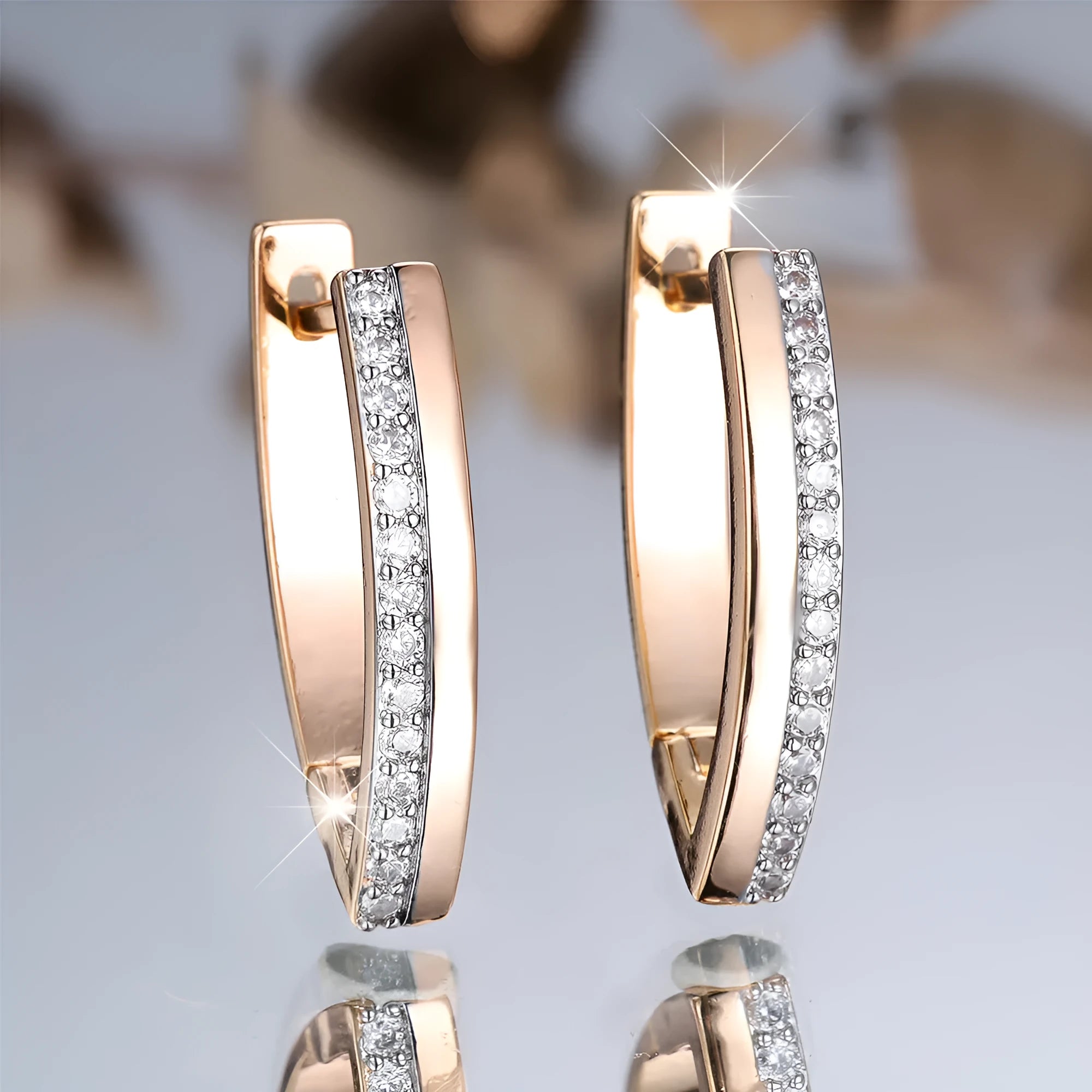 Geometric V-shaped women's ear clips in champagne gold with white diamond accents
