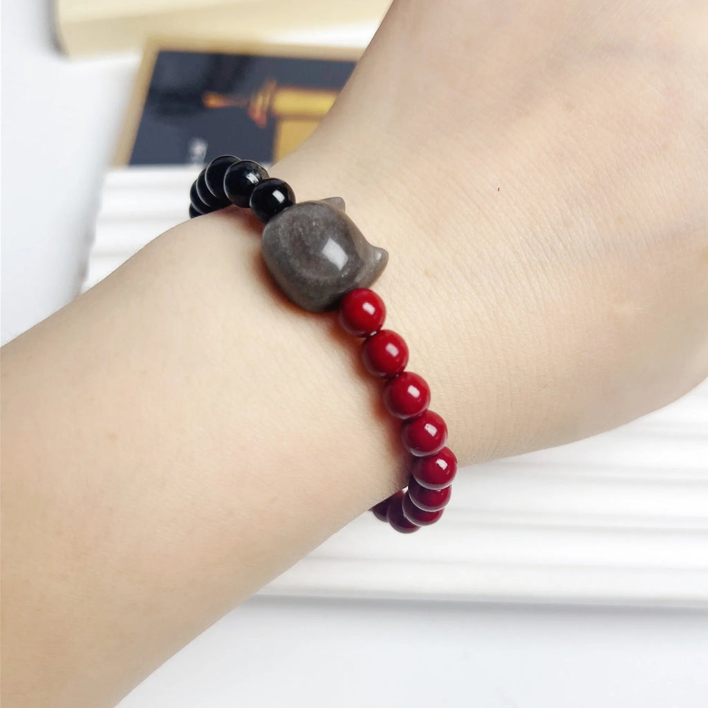 Handmade obsidian colour cat bracelet with carved black cat charm and colourful beads on black elastic cord