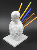 White American character modelling pen holder on desk holding multiple pens, 10cm tall synthetic resin organiser