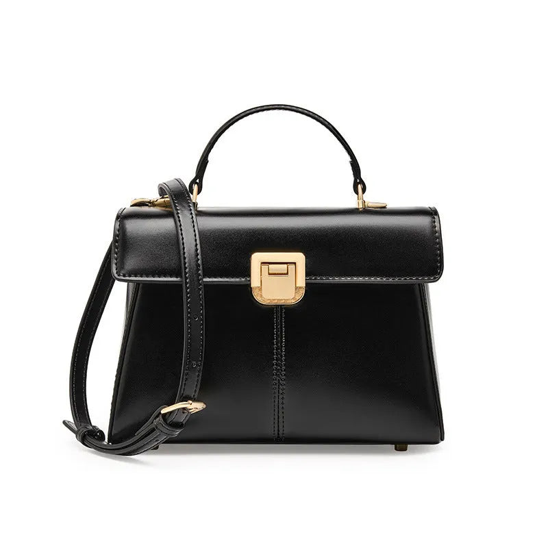 Black leather women's shoulder bag with clasp closure showing internal zippered compartment and adjustable strap