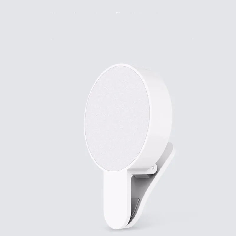 White clip-on LED selfie light for mobile phones showing three-level dimming buttons and USB port.