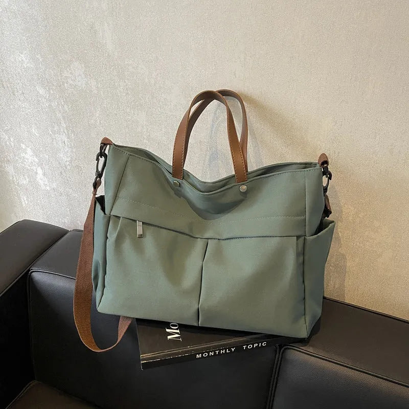 Nylon crossbody tote bag with shoulder strap in black, grey, white, or green