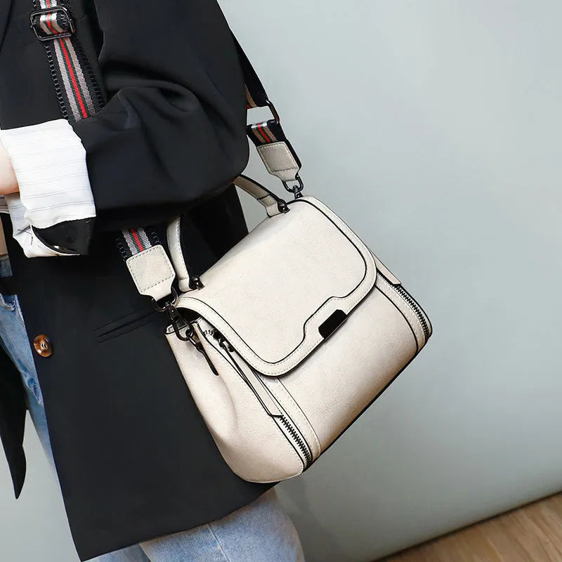 Women's brown genuine oil wax leather messenger bag with double shoulder straps and visible sewing lines