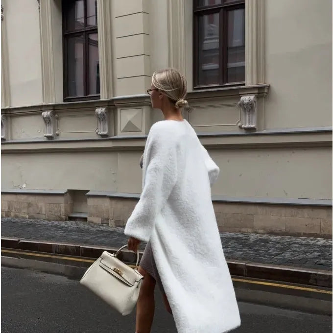 White women's knitted cardigan jacket with 105cm length and loose fit, shown in commute style