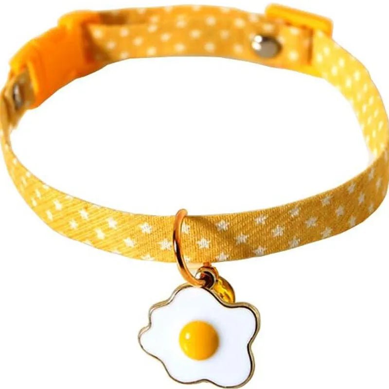 Adjustable cat collar with bell pendant and bow tie on small dog showing 17-33cm sizing range