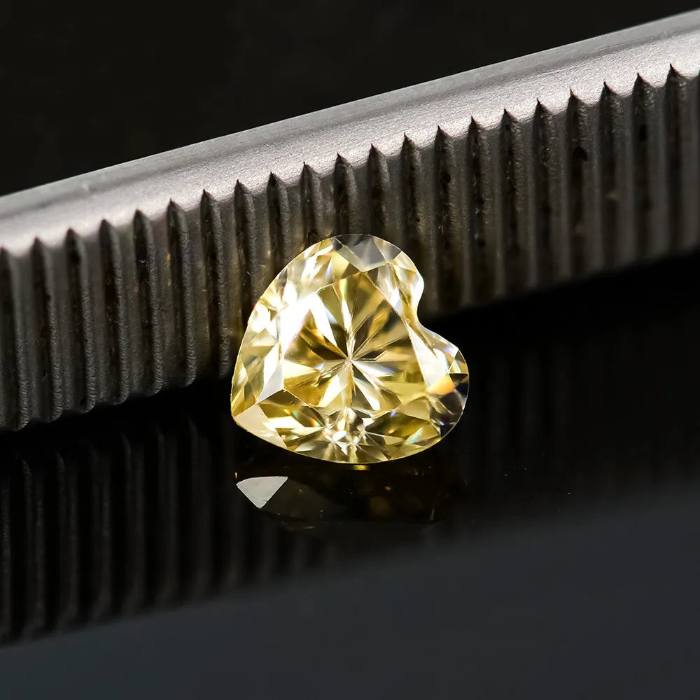 Heart-shaped moissanite stone in lemon yellow colour showing 5x5mm size with heart cut faceting
