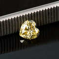 Heart-shaped moissanite stone in lemon yellow colour showing 5x5mm size with heart cut faceting