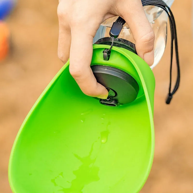 Portable blue pet water bottle with drinking bowl and carrying strap for outdoor use with dogs