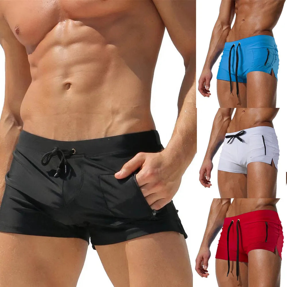 Men's black high-waist swimming trunks with lace-up front closure, shown on model during swimming activity