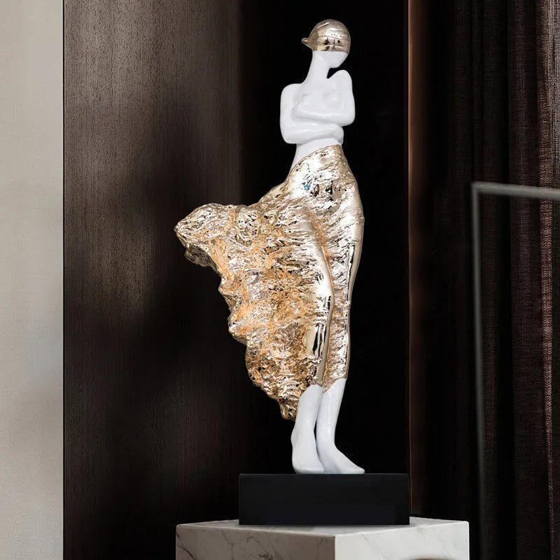 48cm tall sculptured character ornament in natural resin with rose gold finish on wooden surface