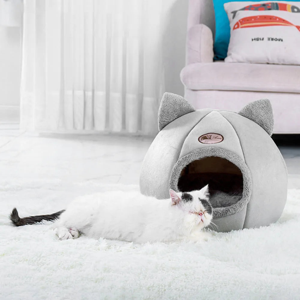 Large fully enclosed fabric cat house with a single entrance, shown in a home setting.