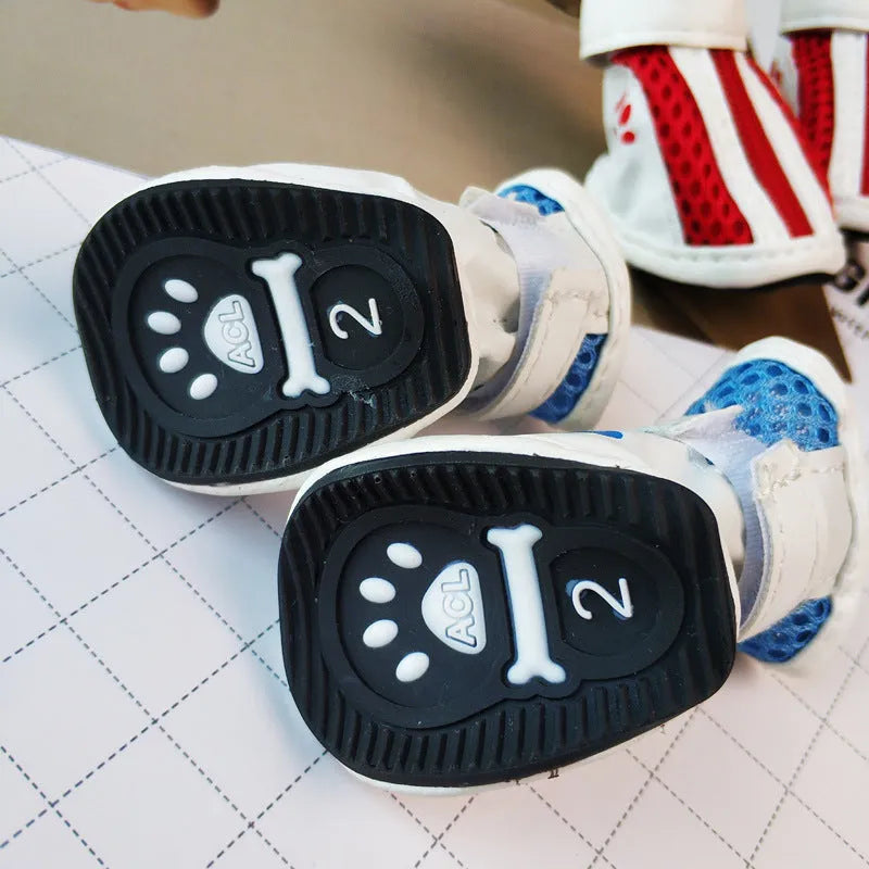 Blue zip-up dog boot for small pet on a wooden floor.