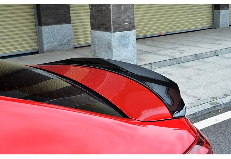 Bright black Mazda 3 Axela Exela tail trim with large fixed wind surround for 2014-2021 models
