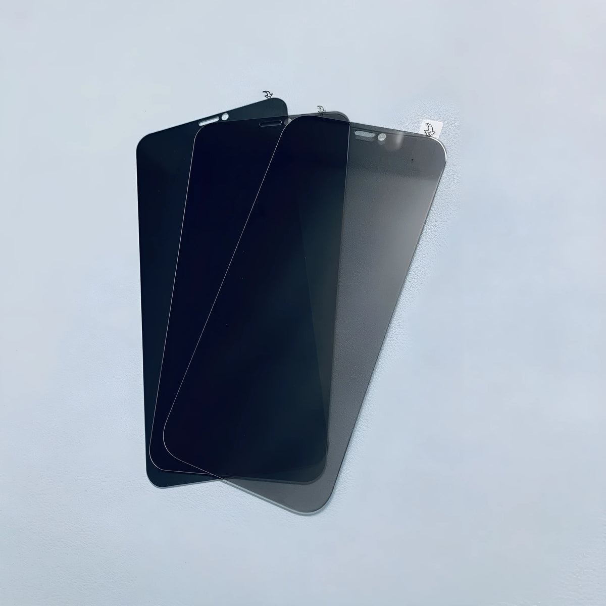 Tempered glass privacy screen protector for iPhone showing narrow viewing angle effect.