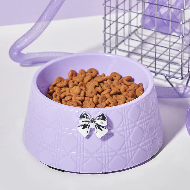 Decorative pet bowl with bowknot and diamond pattern in pink, silver, black, purple, and white colours.