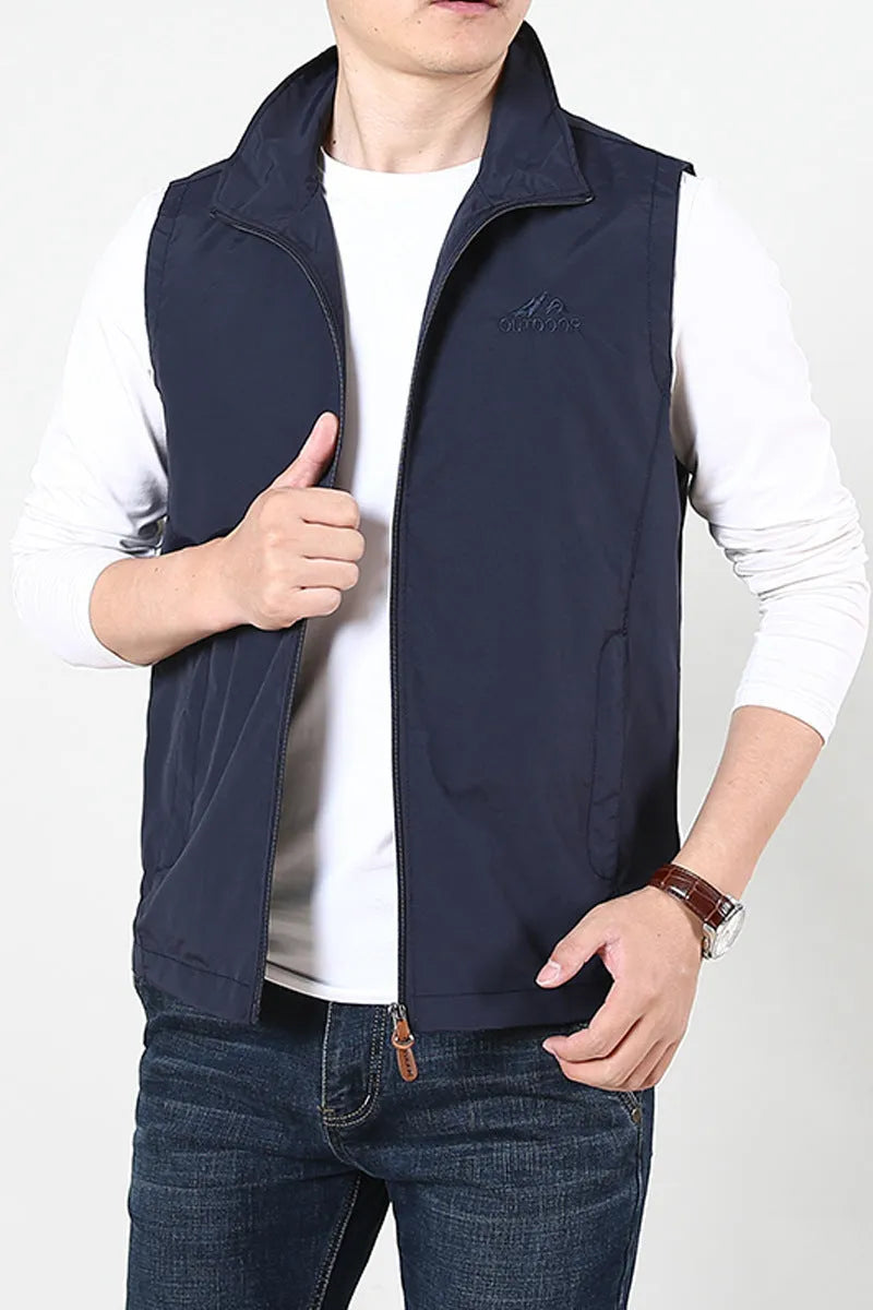 Men's solid colour thin waistcoat vest with side pockets shown in khaki colour, laid flat.