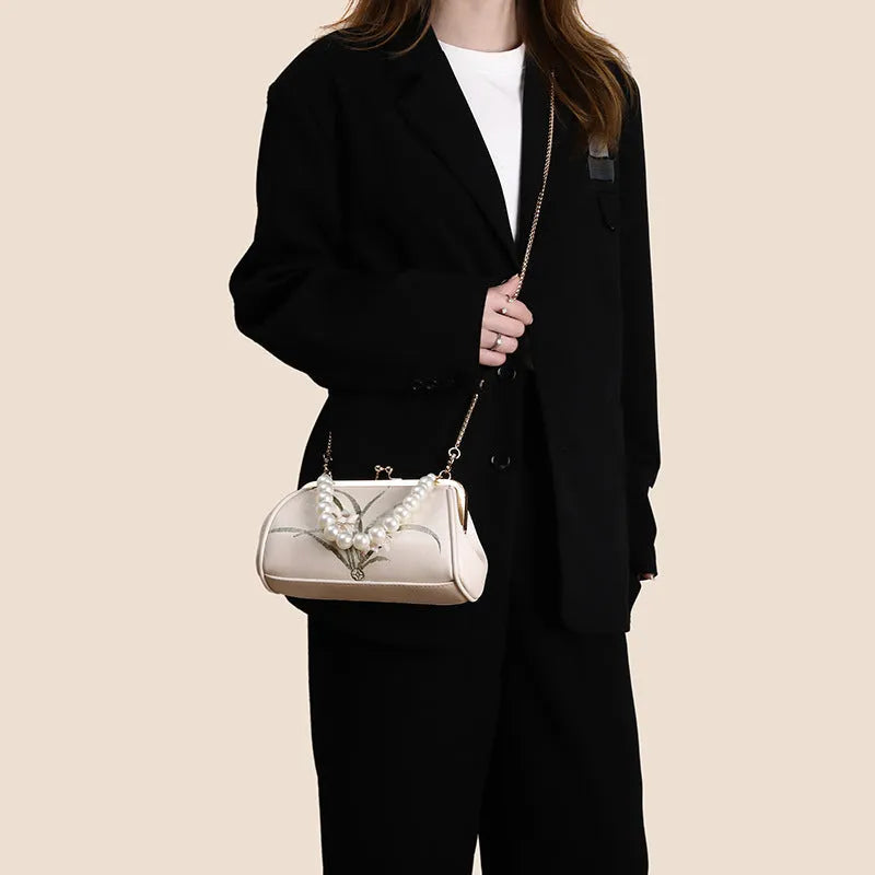 Beige women's embroidered shoulder bag with shell shape design in soft PU material