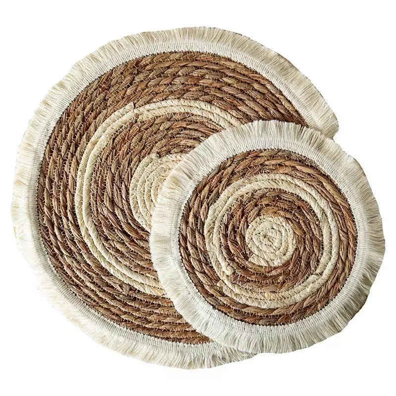 Round Japanese straw placemat with decorative tassels in natural papyrus colour, showing handwoven texture