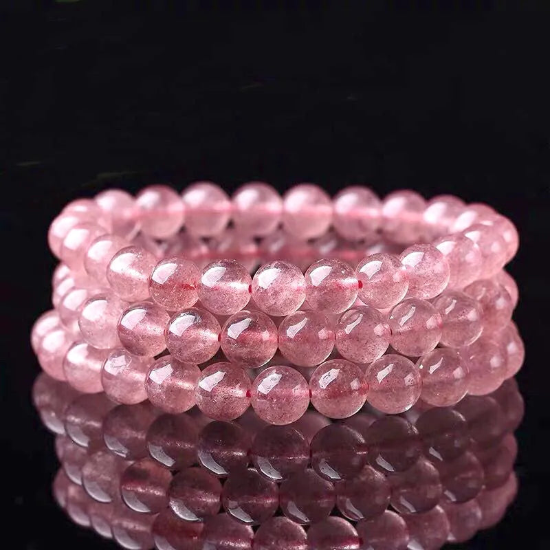 Women's strawberry quartz bracelet with polished crystal beads in 6mm, 8mm, or 10mm sizes on a wrist