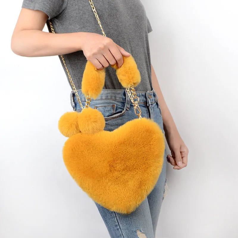 Women's plush heart-shaped handbag with single adjustable strap in various solid colours
