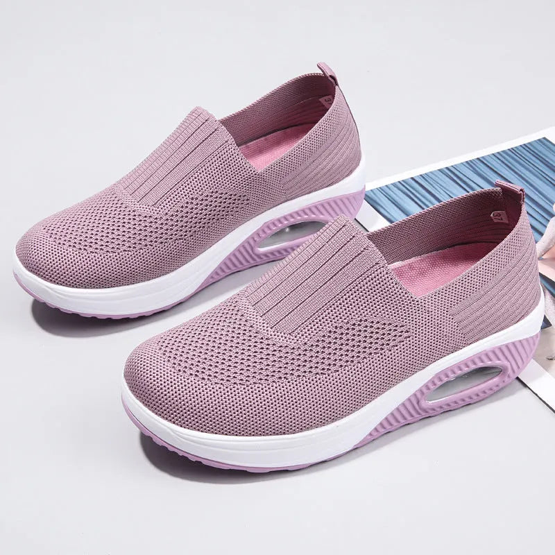 Women's casual mesh running shoes in light grey with round toe and air cushion sole, shown on a foot.
