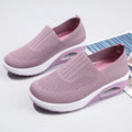 Women's casual mesh running shoes in light grey with round toe and air cushion sole, shown on a foot.