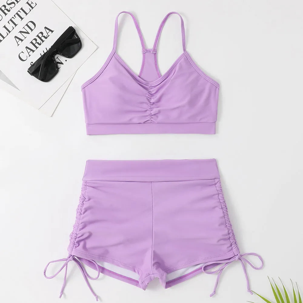 Women's high-waisted split swimsuit in purple or black, showing sleeveless design and split style for swimming.