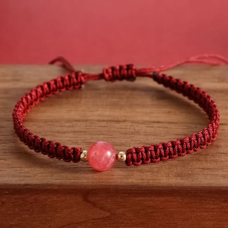 Woven red rope bracelet with spherical strawberry quartz beads and alloy clasp
