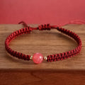 Woven red rope bracelet with spherical strawberry quartz beads and alloy clasp