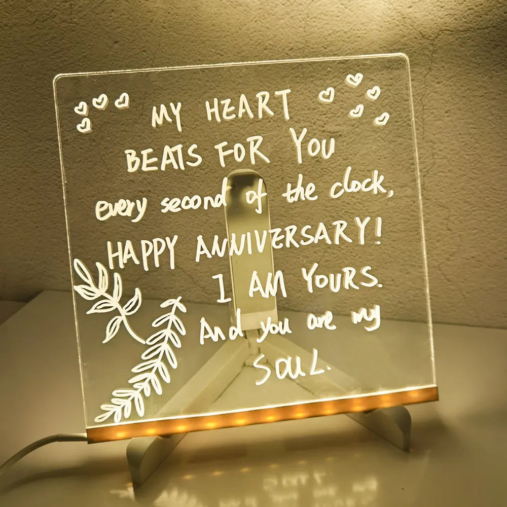 Acrylic DIY LED message board night light on a desk with handwritten drawing glowing softly.