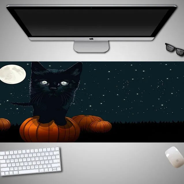 Oversized Halloween-themed mouse pad on desk with non-slip rubber cloth base and large surface area