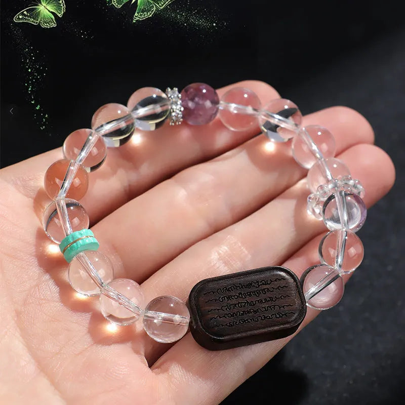 Natural white crystal ebony five warp bracelet on wrist showing wooden beads and ethnic design