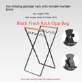Black folding iron trash rack with wood handle holding bin bag outdoors