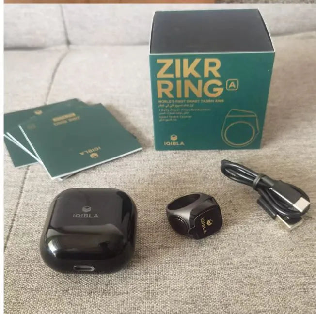 Zikr1 smart ring in silver with 0.49-inch OLED display showing time and Tasbih count on a finger