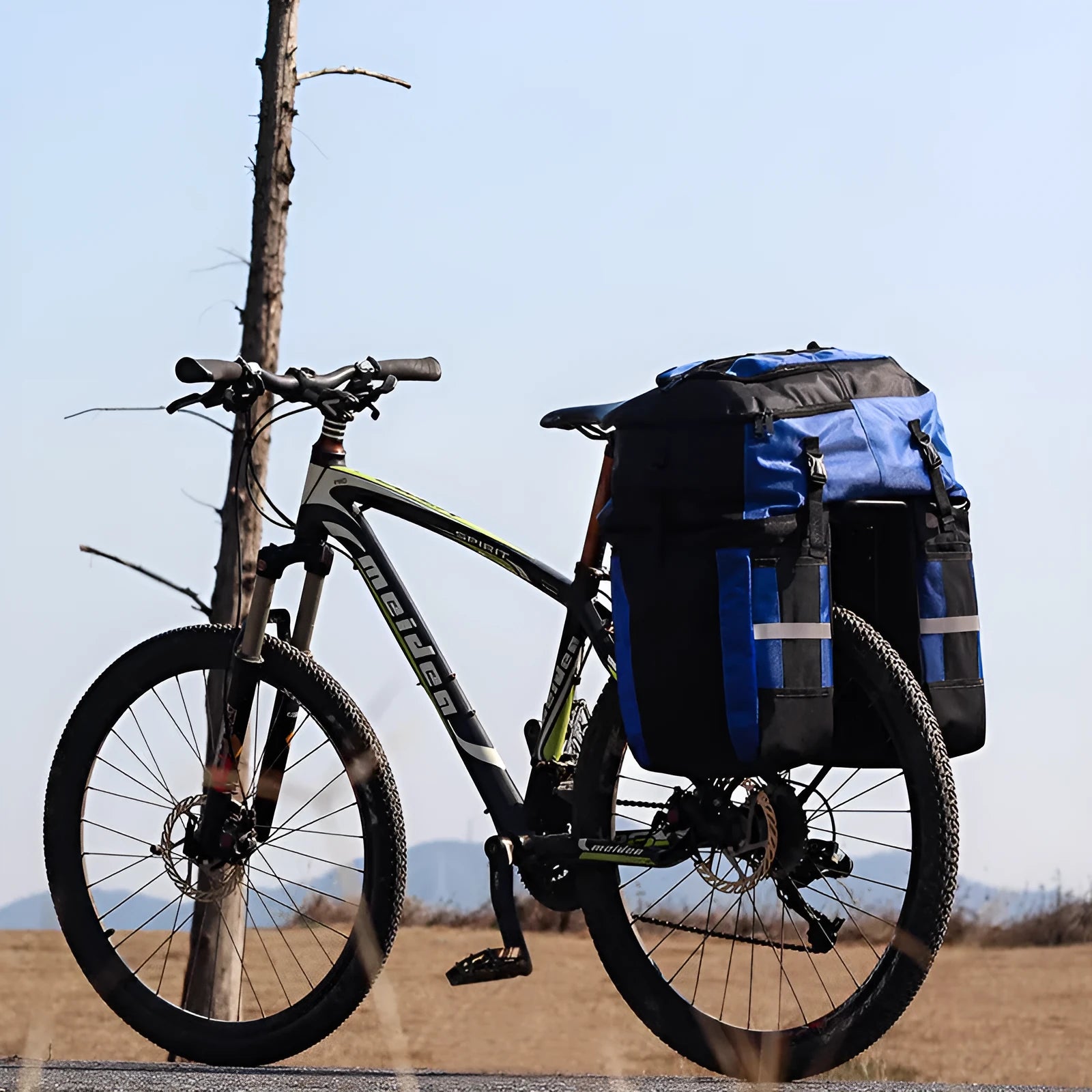Rhinoceros brand 70-litre capacity bicycle rear frame storage bag in blue, mounted on a bike for touring.
