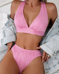 Women's pink halter strap bikini swimsuit with matching shorts on a mannequin
