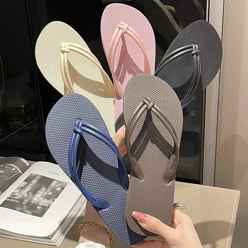 PVC women's flip flops in pink with a non-slip sole and toe-covering strap.