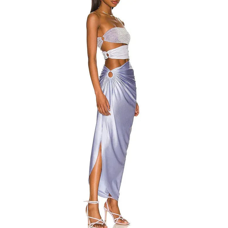 Purple one-piece swimsuit with high-cut legs and a matching wrap skirt laid flat.