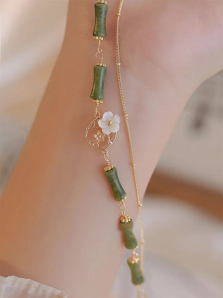 Natural olivine bracelet with double layer design featuring twin bells and olive branch motif
