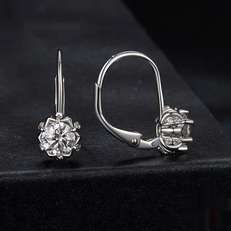 Close-up of a sterling silver floral ear clip with moissanite stone and white gold plating
