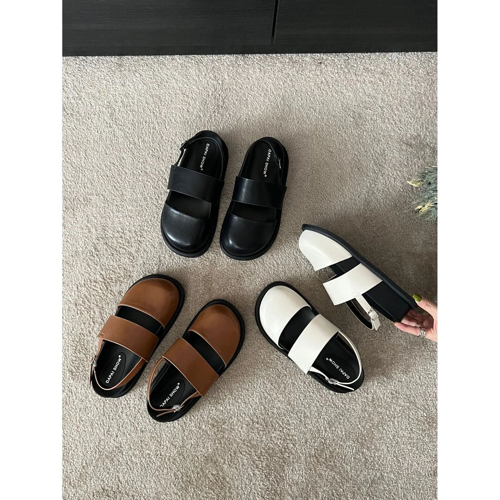 Retro raised sole sandals with ankle-strap buckle in black microfiber