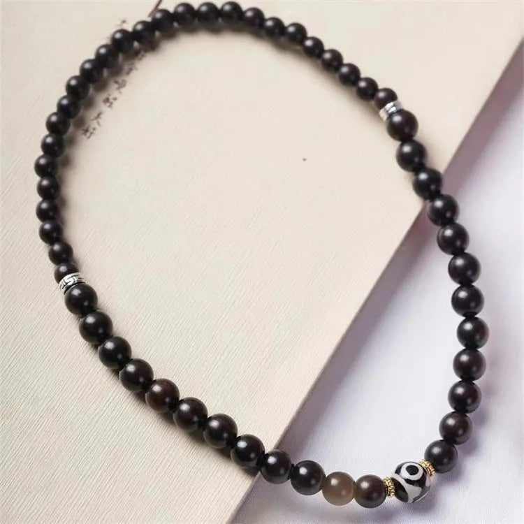 Solid ebony wood Tibetan bead bracelet with two circular 8mm beads on wrist
