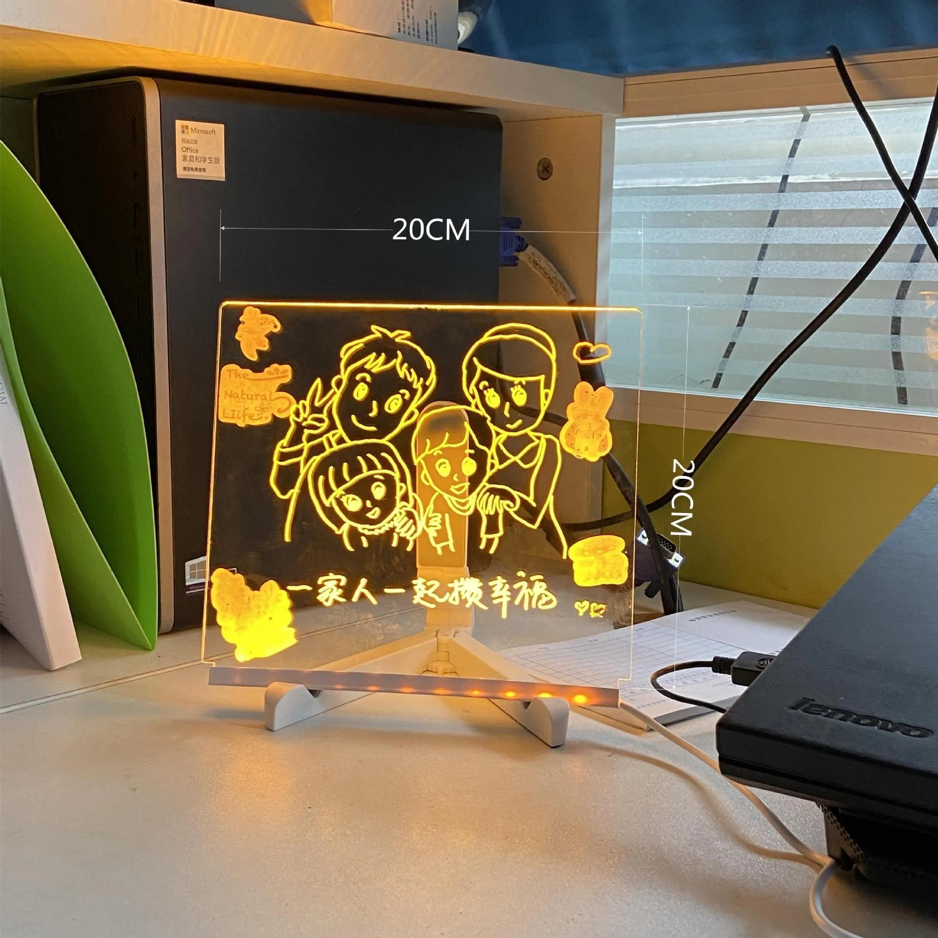 Acrylic DIY LED message board night light on a desk with handwritten drawing glowing softly.