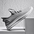 Men's summer casual shoes with flying weave upper, front tie lacing, rubber sole, available in black, coffee, grey, sizes 39-44.
