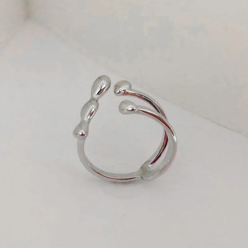 Adjustable brass fashion ring with spherical design in gold finish on hand