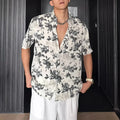 Loose casual printed shirt with short sleeves and floral pattern in black or white, sizes M to XXXL.