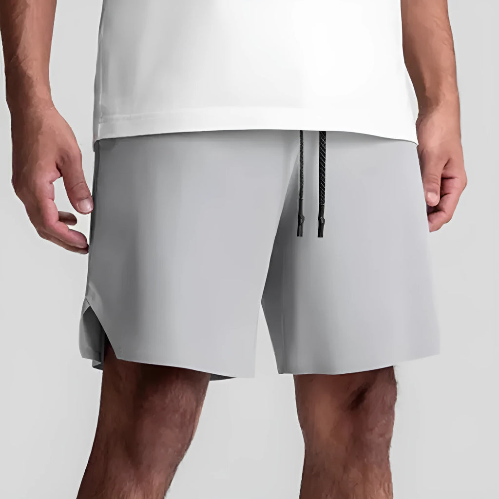 Men's grey seamless sports shorts with knee-length straight leg design and quick-dry fabric